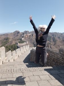 Tracey Gemmell jumping for joy on The Great Wall of China.