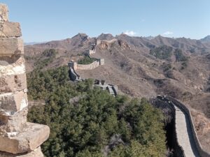 The Great Wall of China winding across hilltops into the distance.