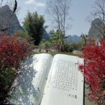 A large book sculpture on the banks of the Yulong River.