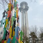 The Beijing Olympic Tower with sculpture in the foreground.