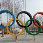 Tracey Gemmell standing by the Olympic rings in the Olympic Park, Beijing.