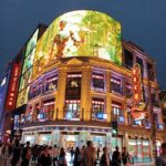 Shanghai billboard with robot image at night.